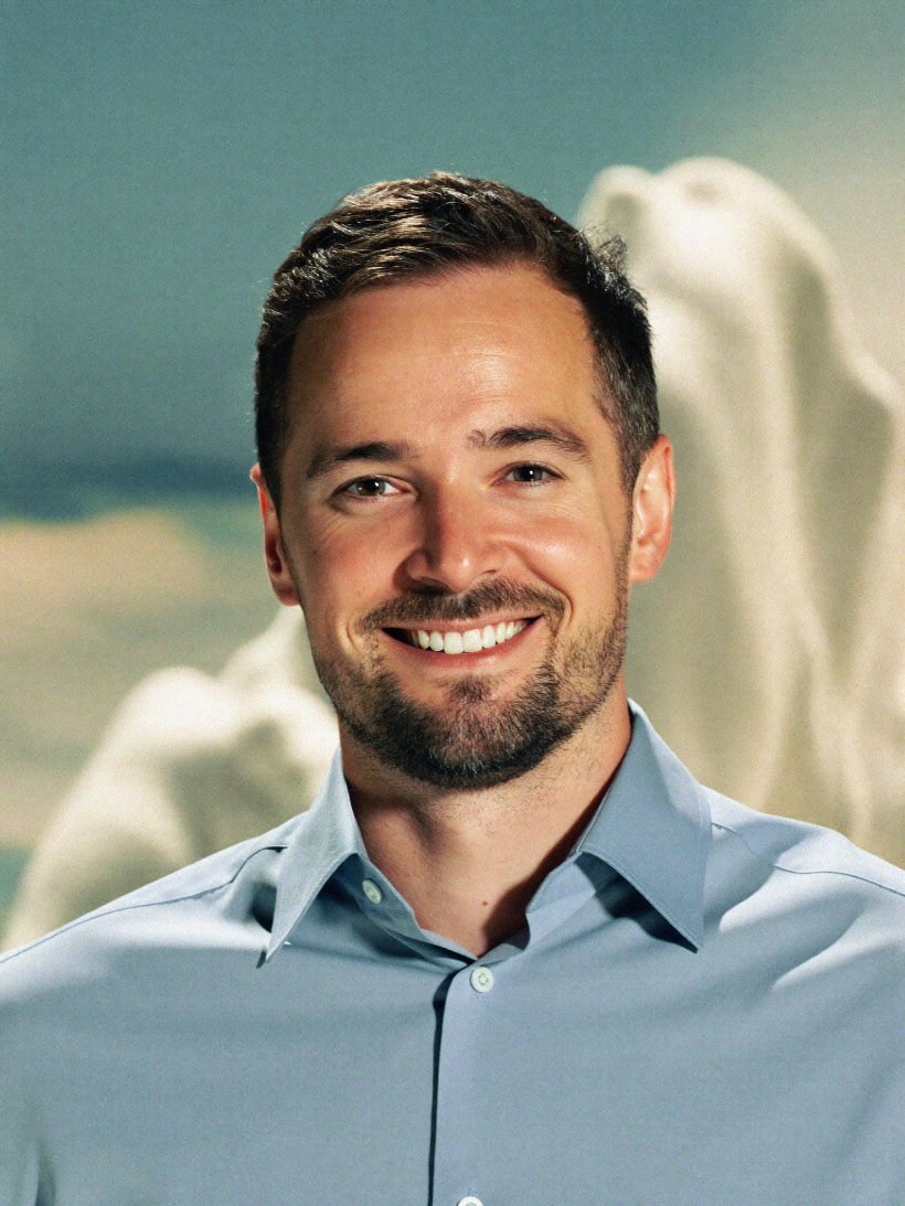 Portrait of a smiling quality manager in a light blue shirt.